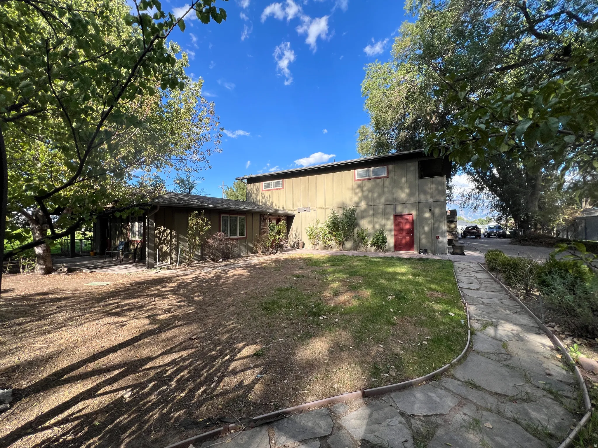 Exterior siding in a neutral tone with a red door accent