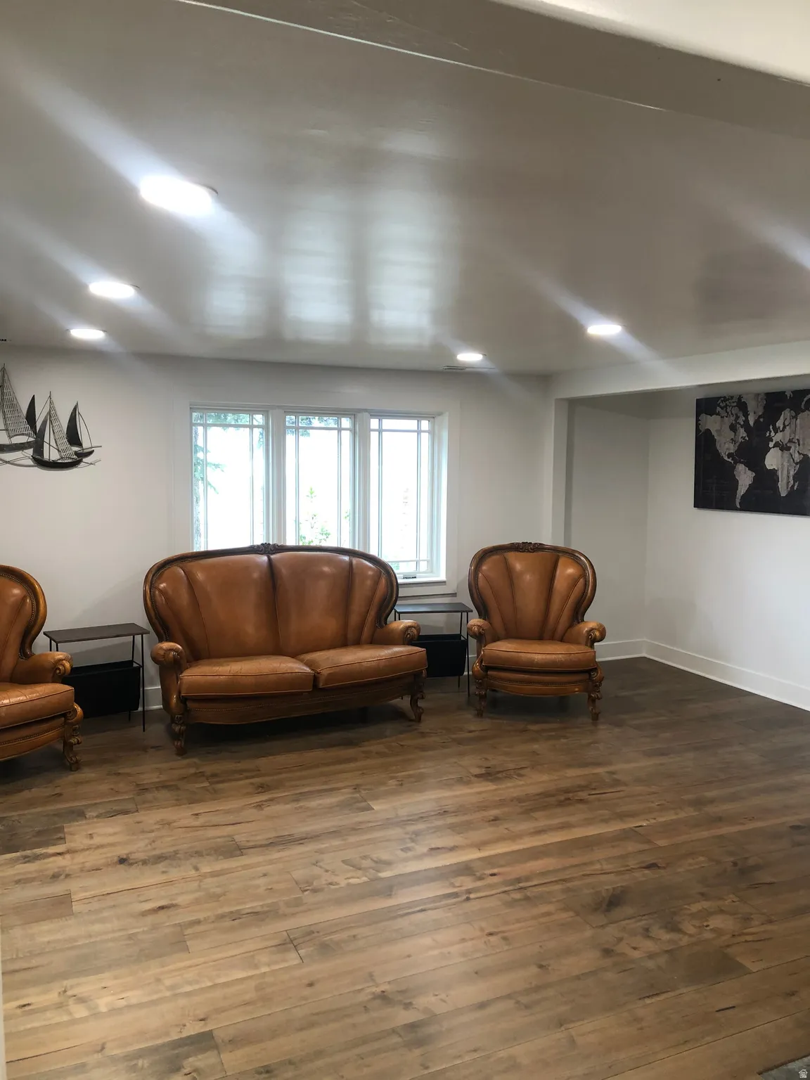 Wood-finish flooring throughout, recessed lighting, and white trim