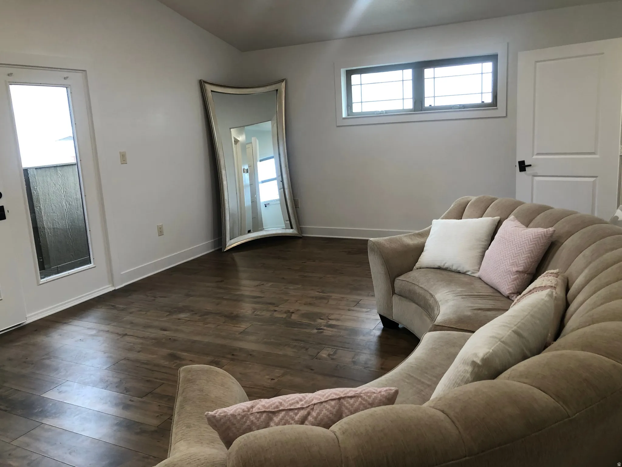 Wood-finish flooring, white walls, and a transom window