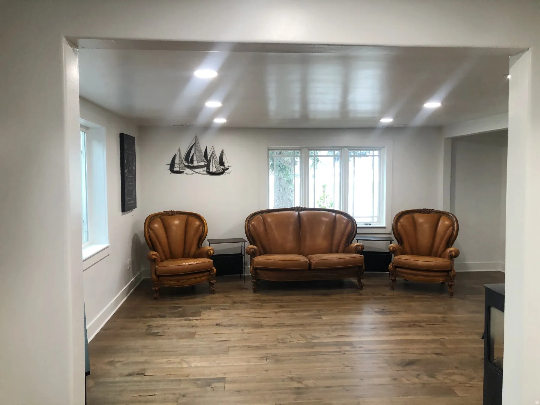 Recessed lighting illuminates wood-finish flooring