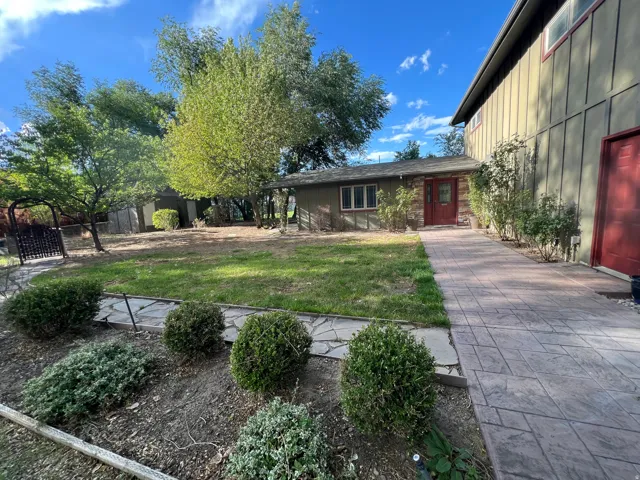 Expansive green space with mature trees and established landscaping