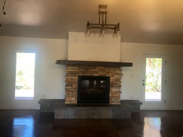 Stone-clad fireplace with a dark wood mantel and hearth