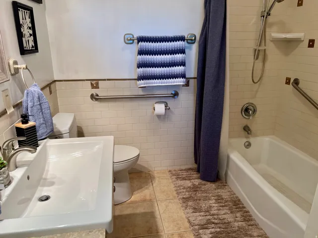 White pedestal sink with a brushed nickel faucet
