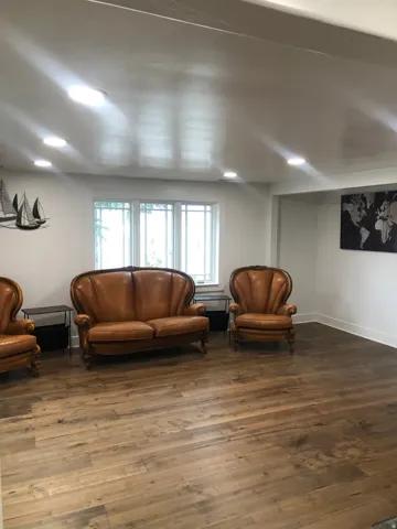 Wood-finish flooring throughout, recessed lighting, and white trim