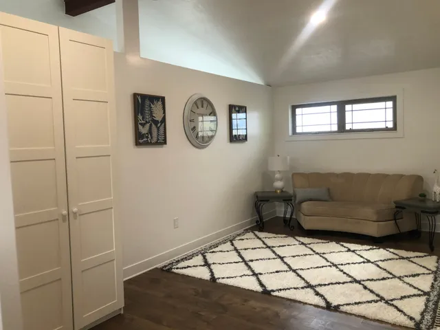 Wood-finish flooring with white baseboards