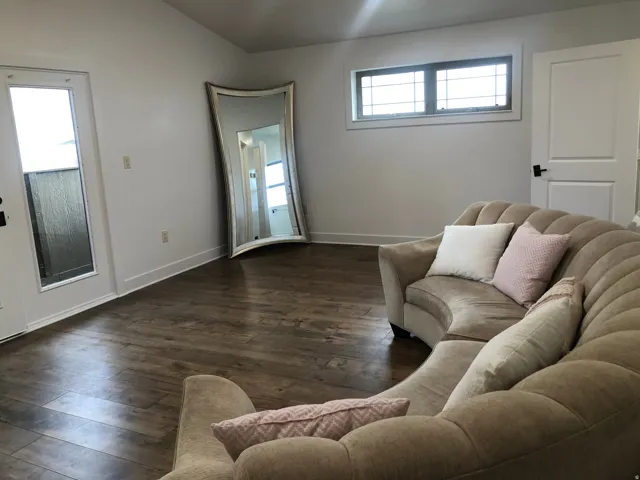 Wood-finish flooring, white walls, and a transom window