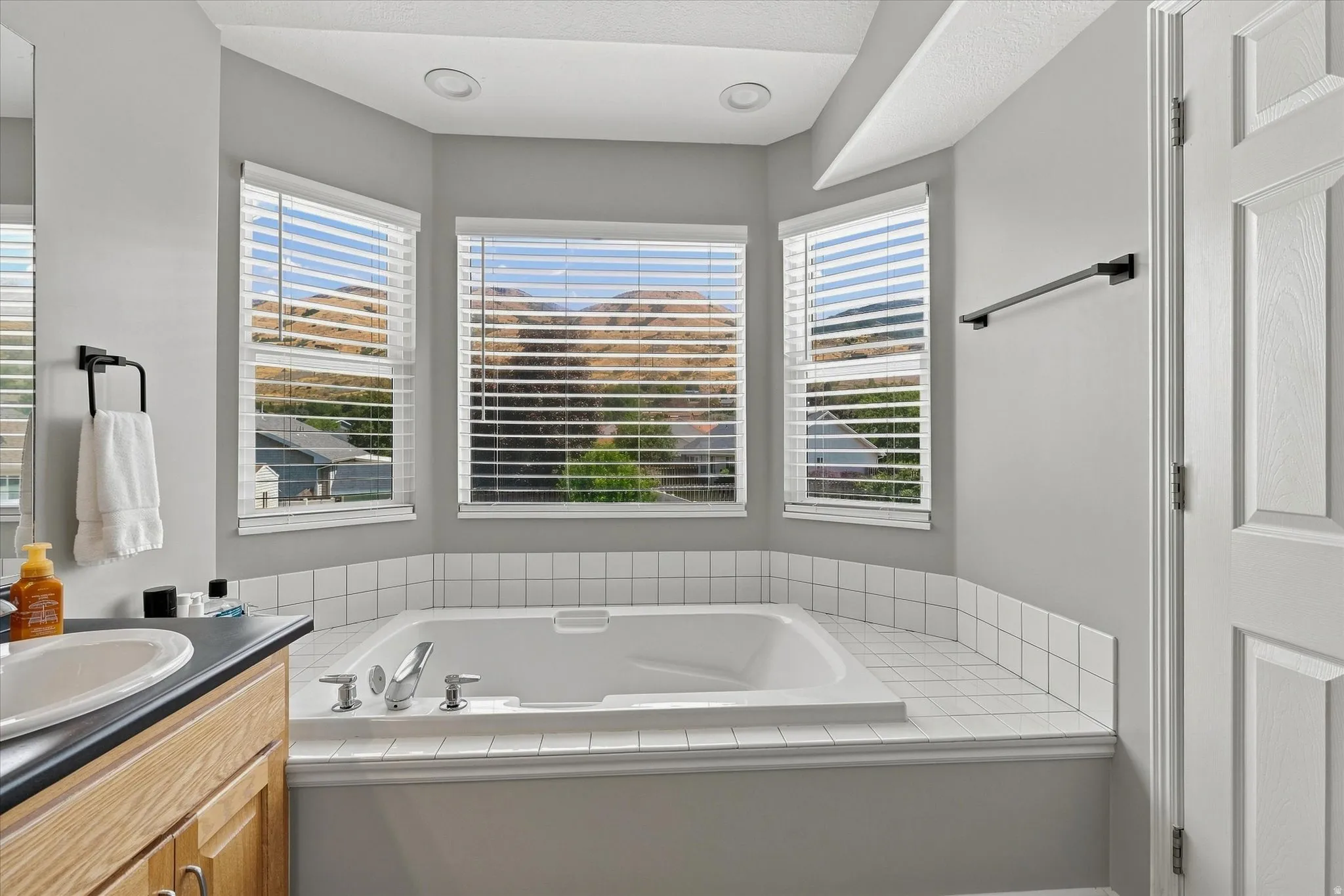 Recessed soaking tub with surrounding white tilework