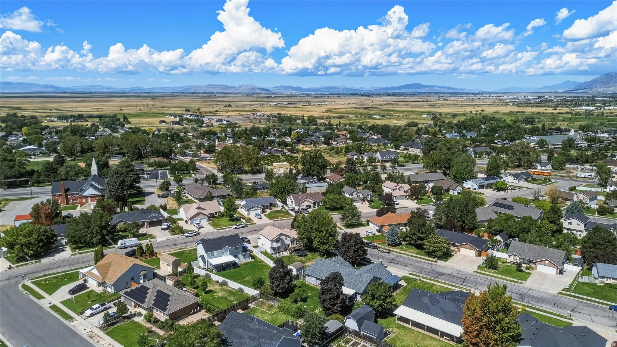 Residential neighborhood featuring single-family homes, mature trees, and paved streets