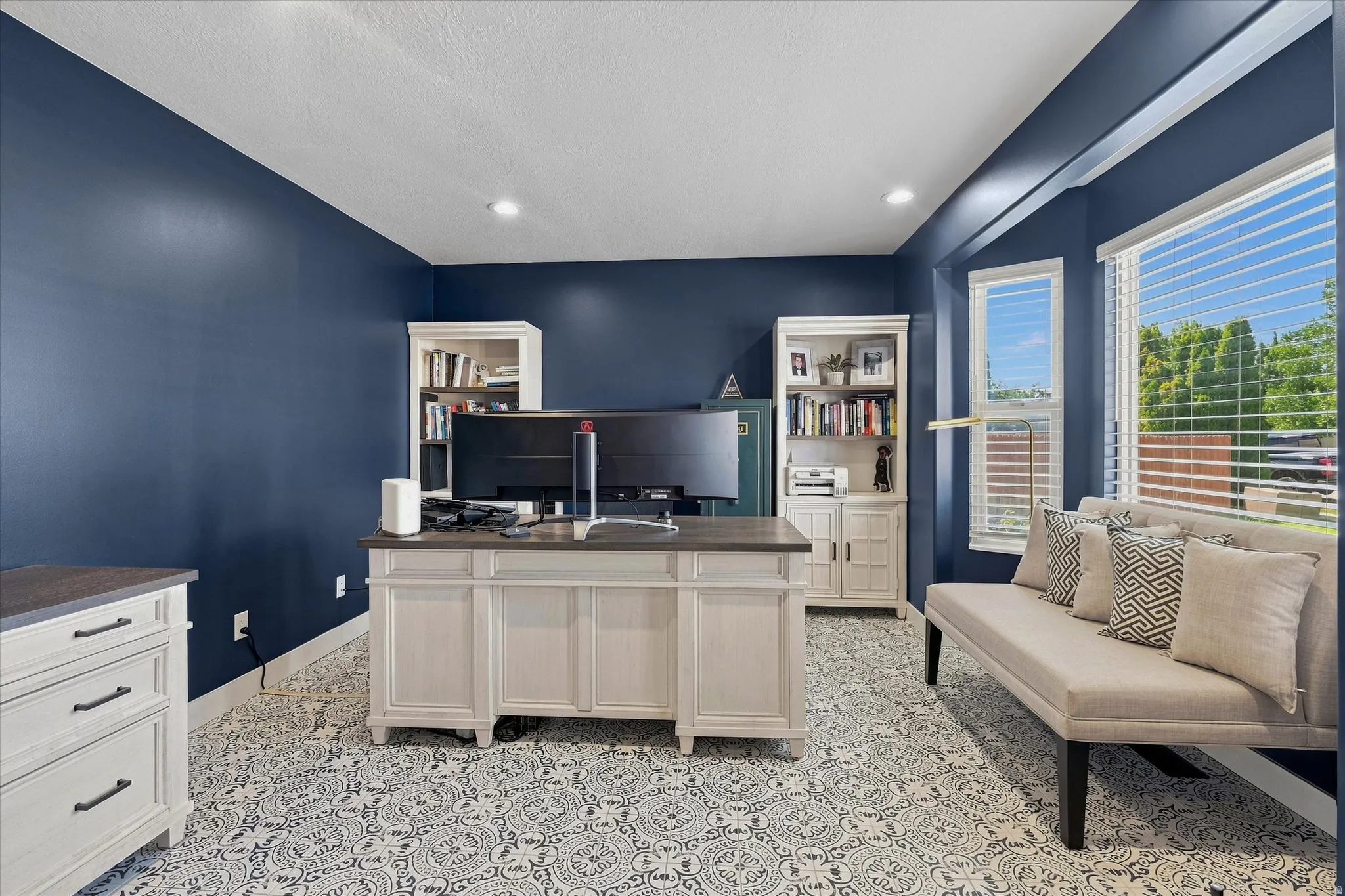 Recessed lighting, patterned floor tile, built-in shelving, bay window with blinds, and painted accent walls