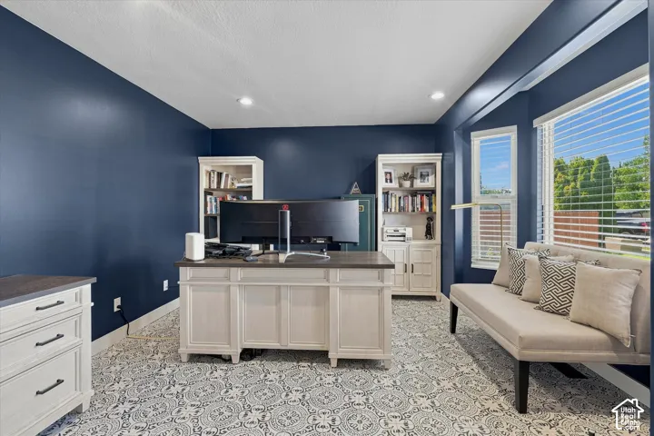 Recessed lighting, patterned floor tile, built-in shelving, bay window with blinds, and painted accent walls