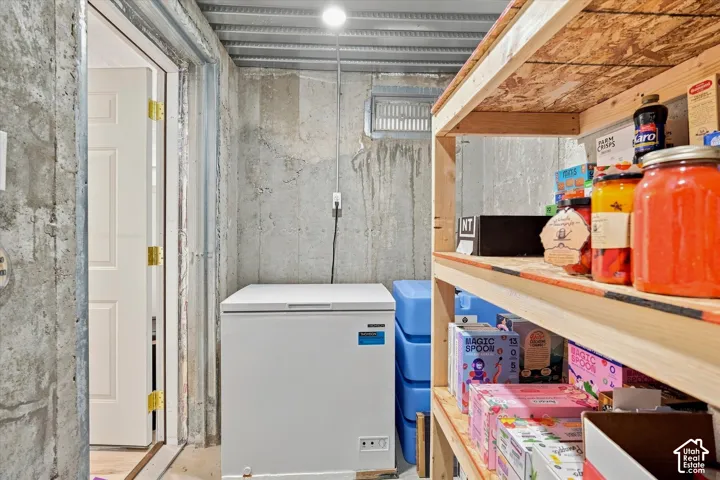 Concrete wall construction with built-in shelving and overhead utility lighting