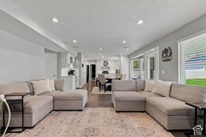 Recessed lighting, wood-finish flooring, white paneled doors, and ample natural light