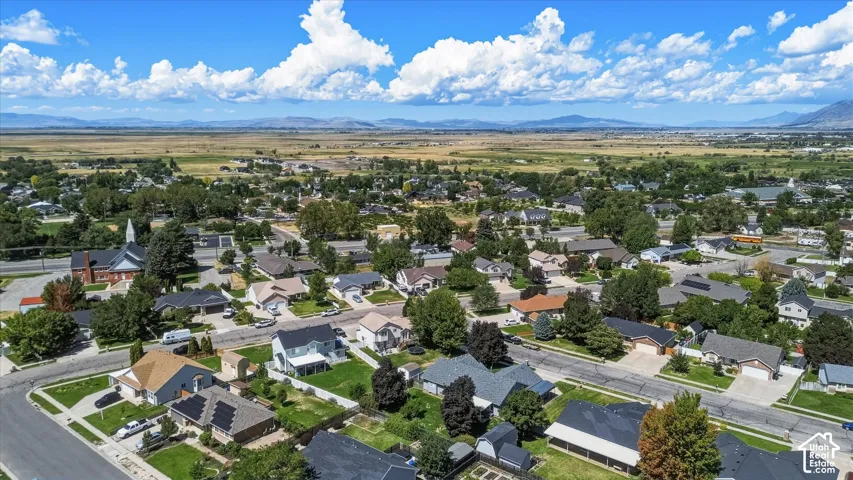 Residential neighborhood featuring single-family homes, mature trees, and paved streets