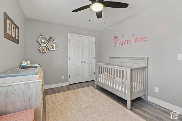 Neutral wall color, wood-finish flooring, ceiling fan, bi-fold closet doors, white baseboards