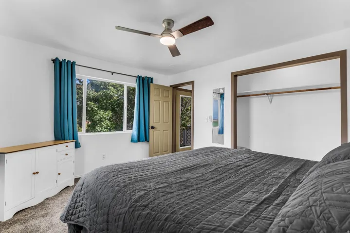 Recessed lighting, ceiling fan, wood-finish door, and open closet with hanging rod