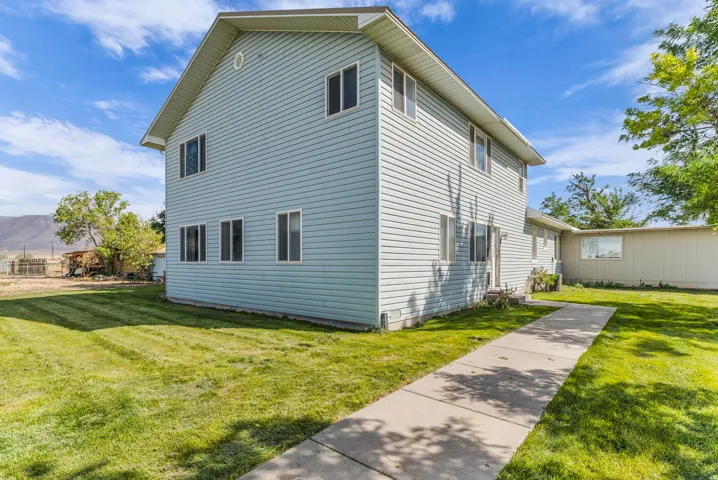 Two-story residential structure with light blue horizontal siding