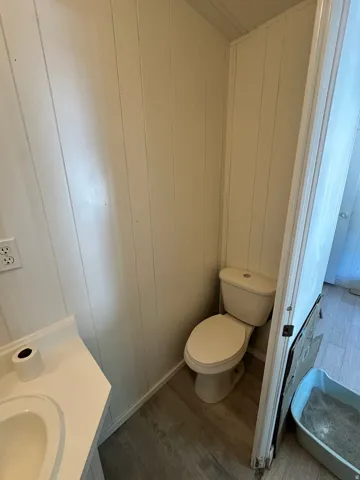 White paneling and light wood-finish flooring