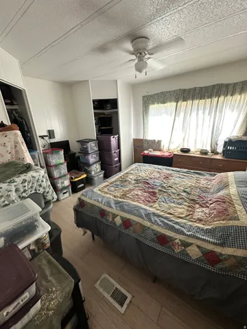 Wood-finish flooring with a ceiling fan overhead