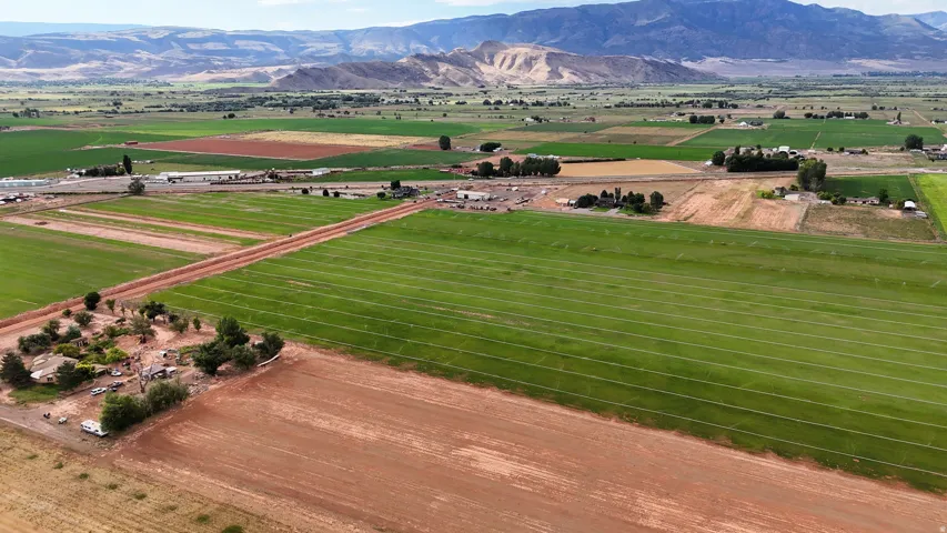 Expansive agricultural landscape featuring cultivated fields and a distant mountain range