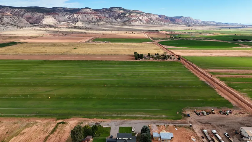 Expansive agricultural property featuring multiple cultivated fields and natural mountain scenery