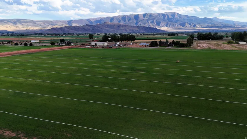 Expansive cultivated fields extending towards distant mountains