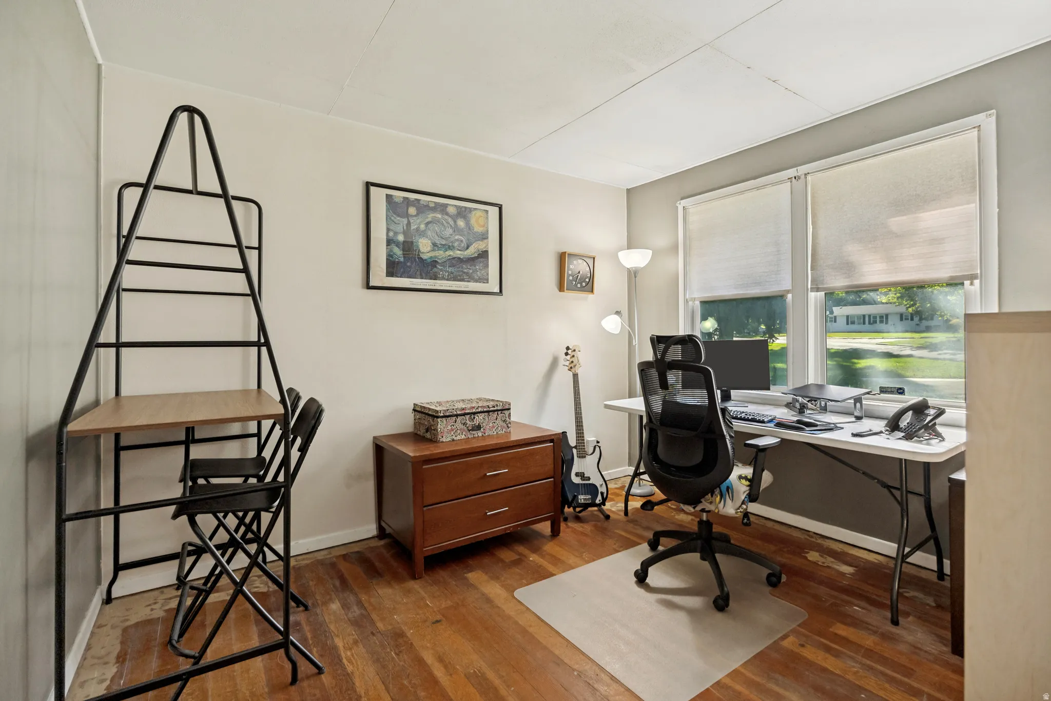 Wood-finish flooring with dual windows, featuring roller blinds