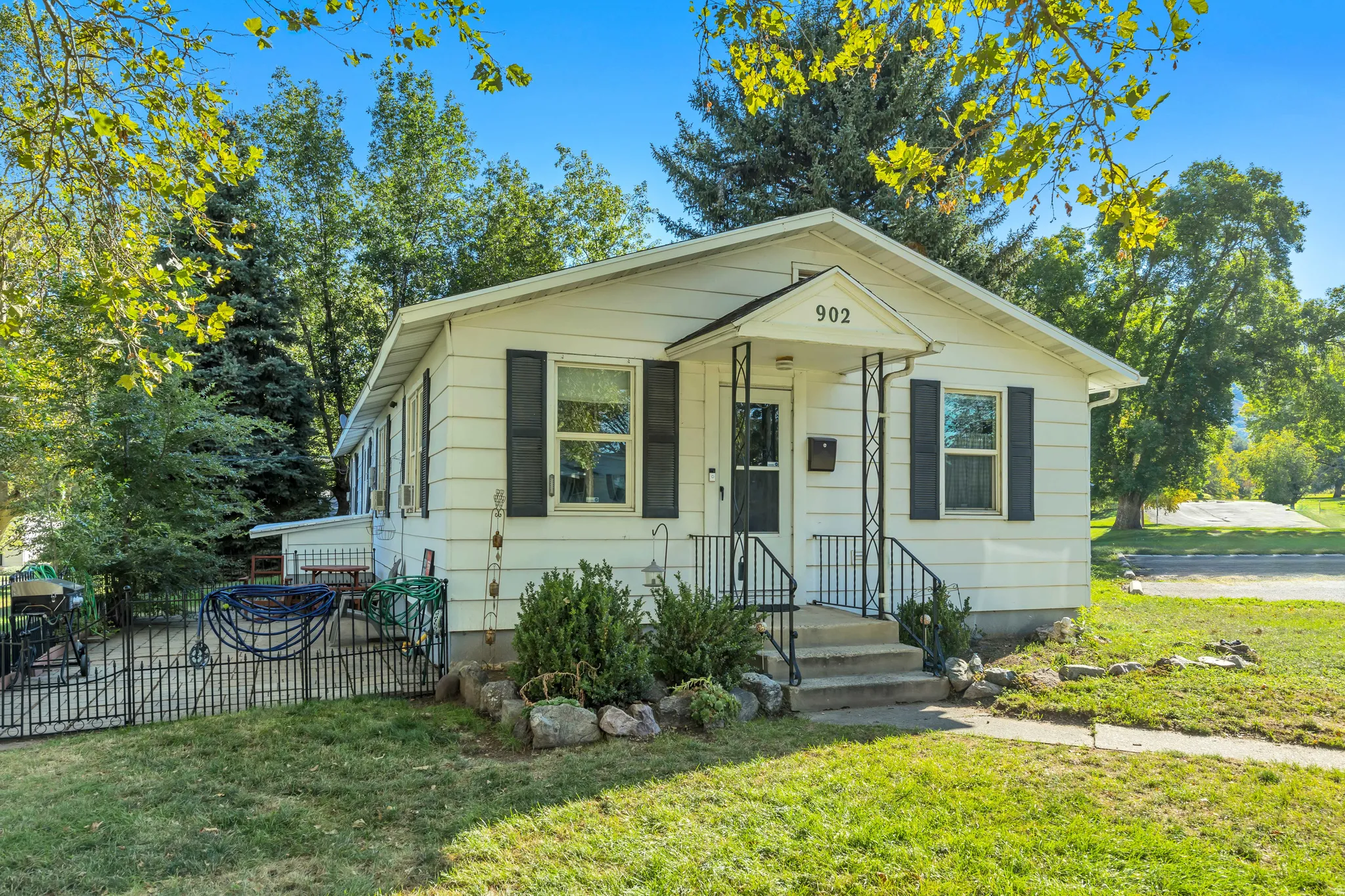 White siding exterior with black window shutters