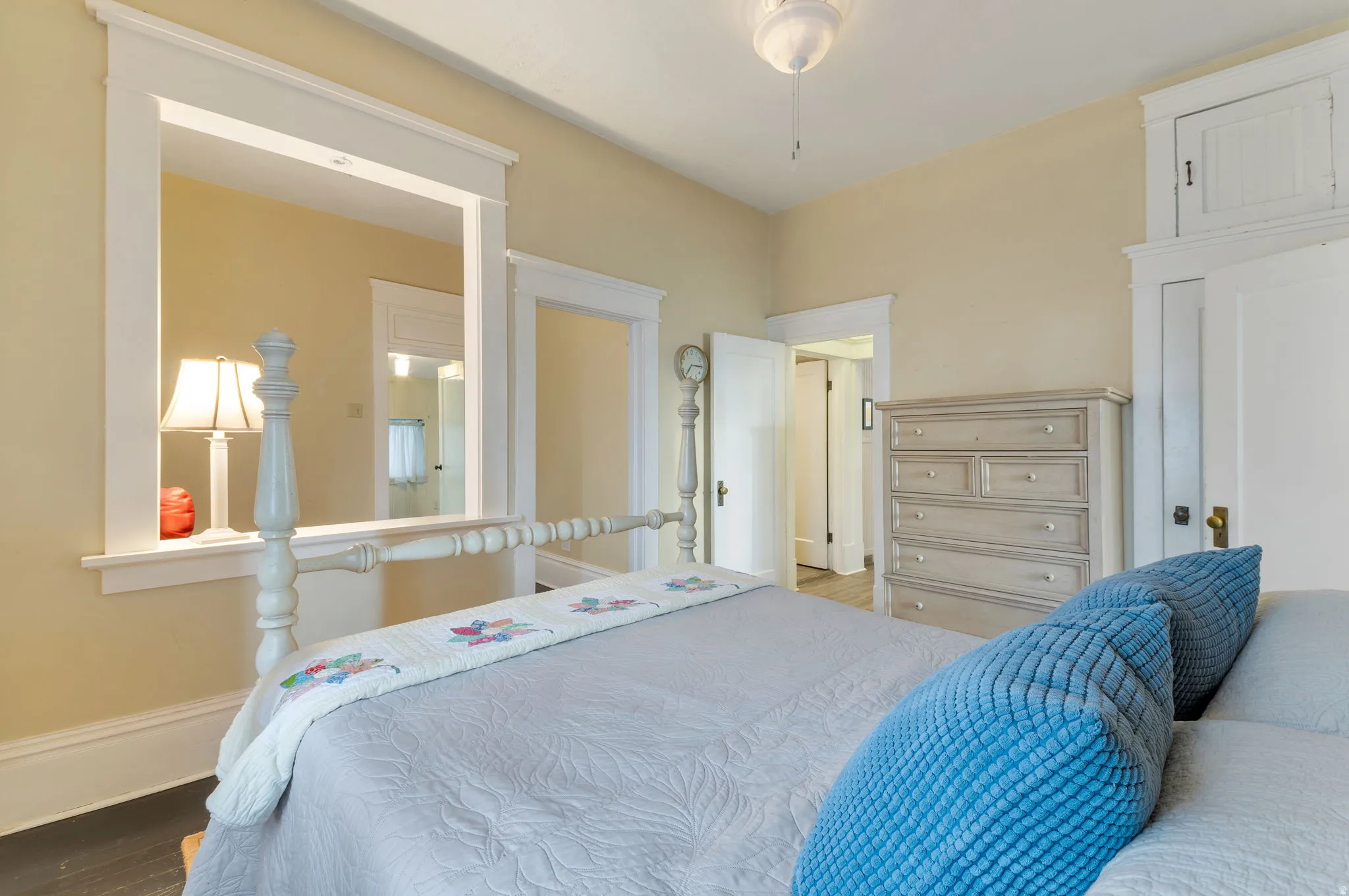 Wood-finish flooring with light-toned walls and white trim