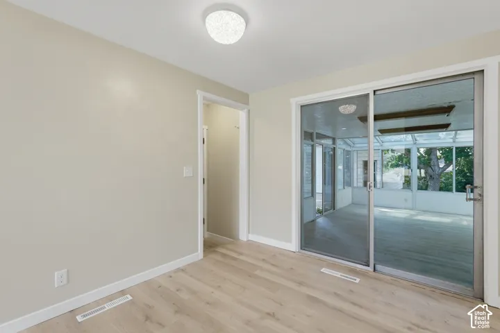 Wood-finish flooring, neutral wall tones, and recessed ceiling lighting