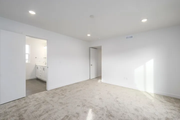 Recessed lighting and neutral carpeting