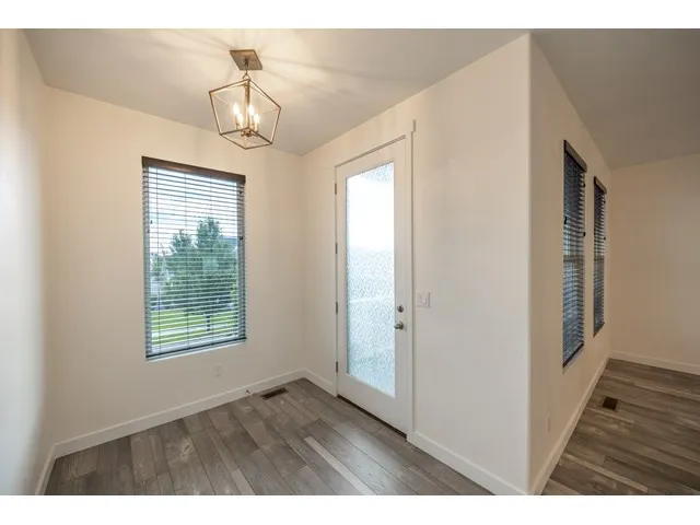 Flex space adjacent to dining area is ideal for a den or office. It opens up to the 2nd level balcony.