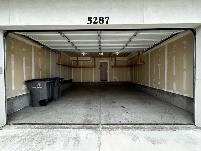 Concrete flooring and built-in overhead storage shelves