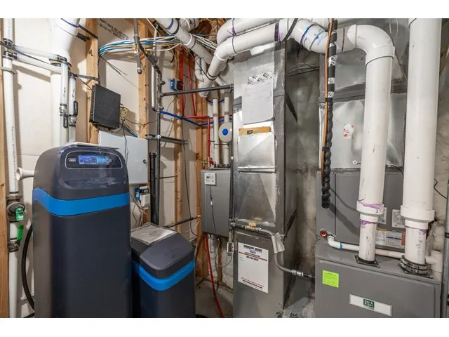 Utility area featuring a water softener, tankless water heater, high efficiency furnace & HVAC