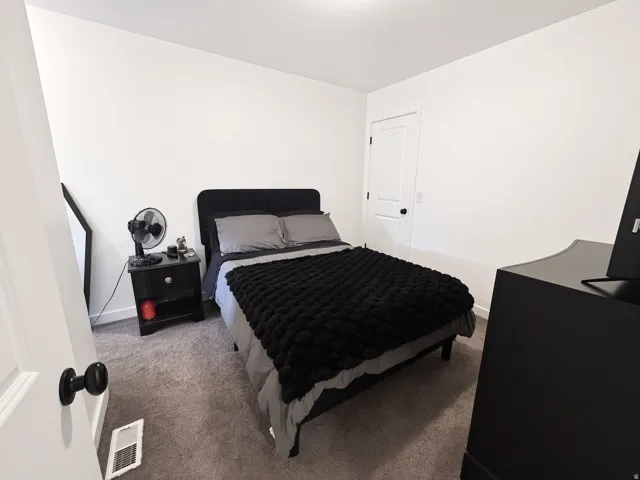 White walls complement the gray carpeting, creating a neutral backdrop