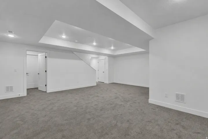 Recessed lighting, gray carpet flooring, white walls, and white trim