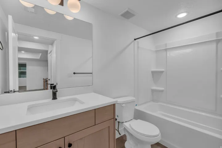 Vanity with white countertop, integrated sink, and matte black faucet