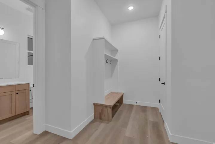 Built-in bench with integrated shelving and coat hooks