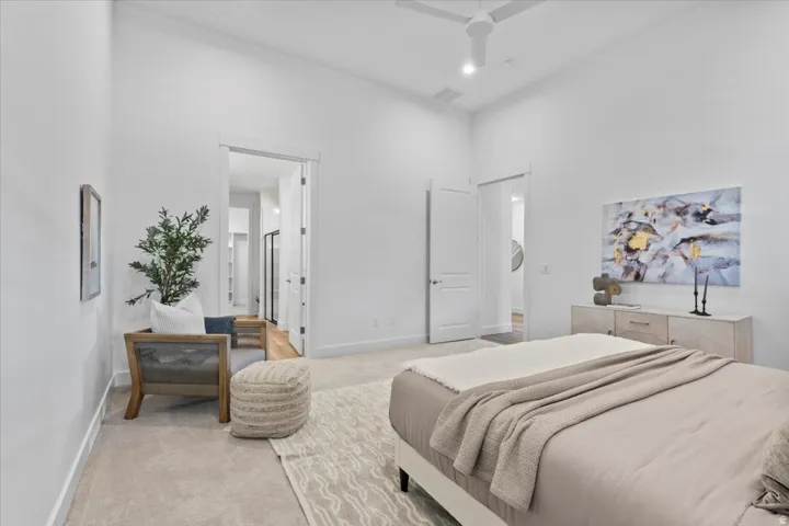 White walls, carpet flooring, a ceiling fan, and recessed lighting