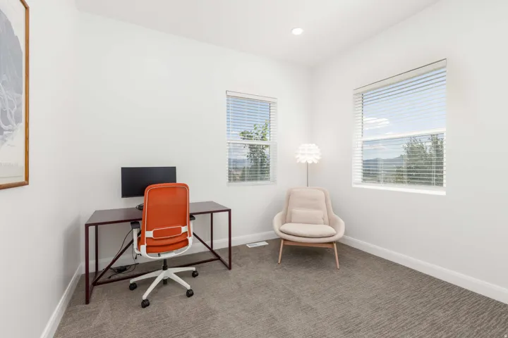 White walls with recessed lighting and two windows