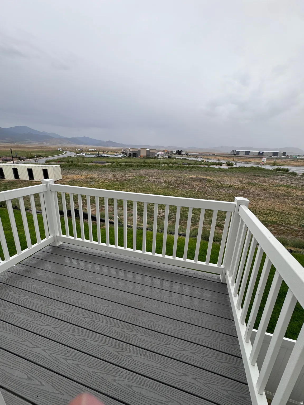Outdoor deck featuring gray composite decking and white railings