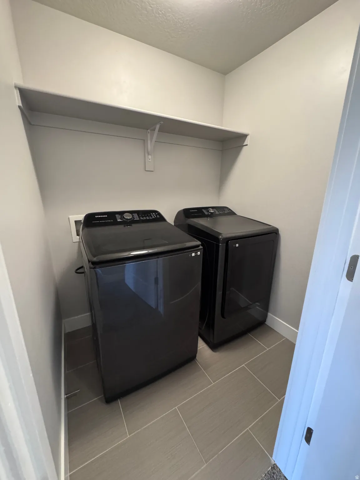 Built-in shelving with support brackets and tile flooring