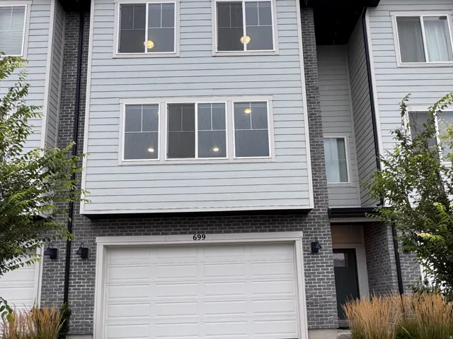 Three-story exterior with horizontal siding and brick accents
