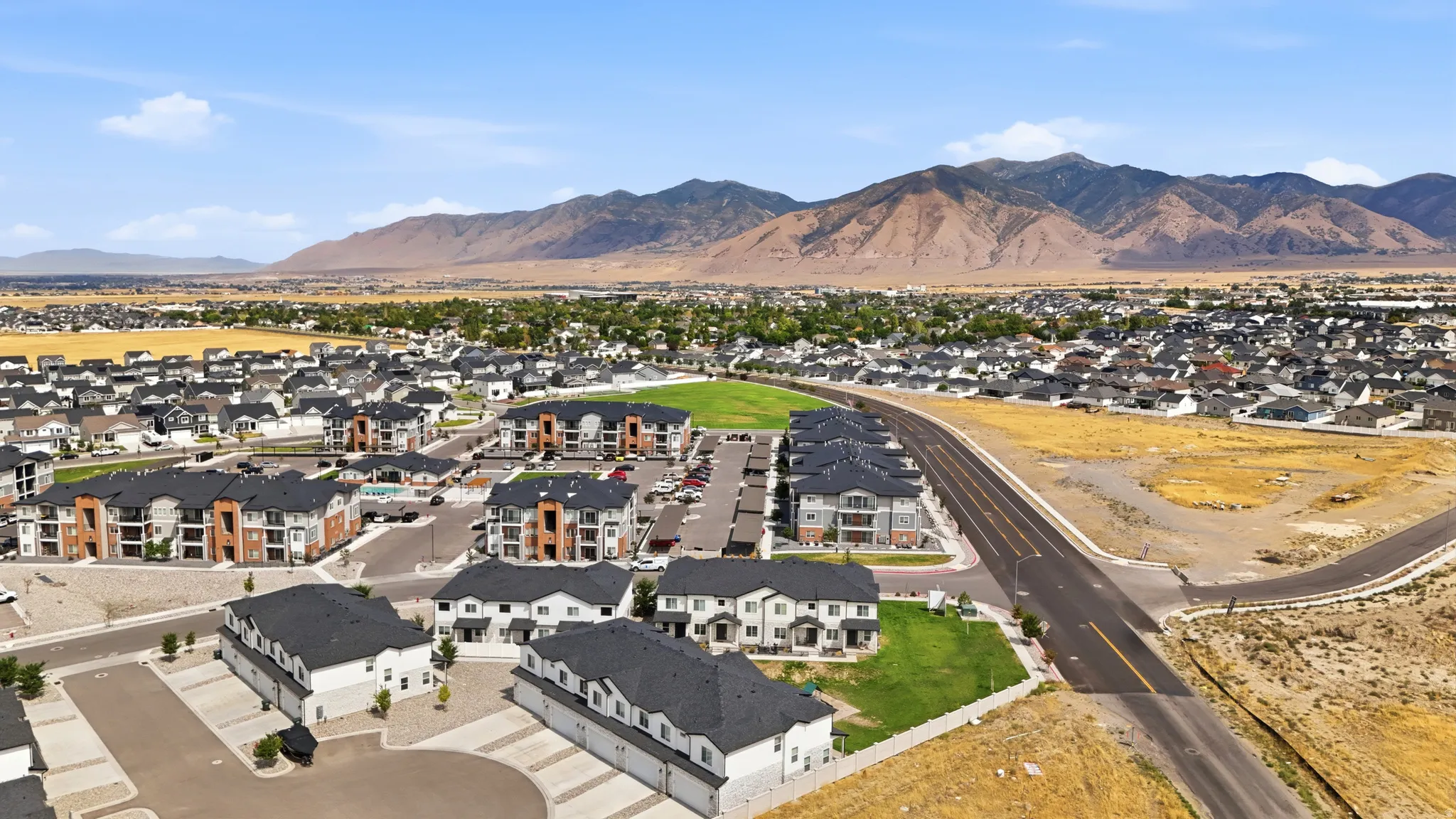 Expansive development featuring a mix of townhomes and multi-story residential buildings