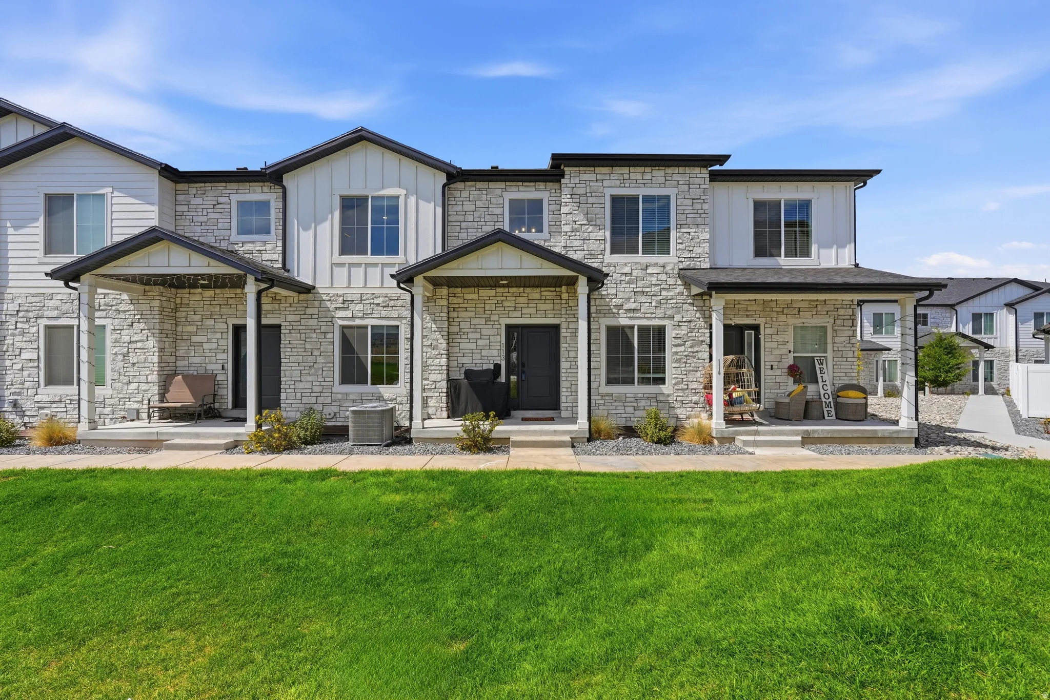 Stone veneer and siding exterior with dark trim accents