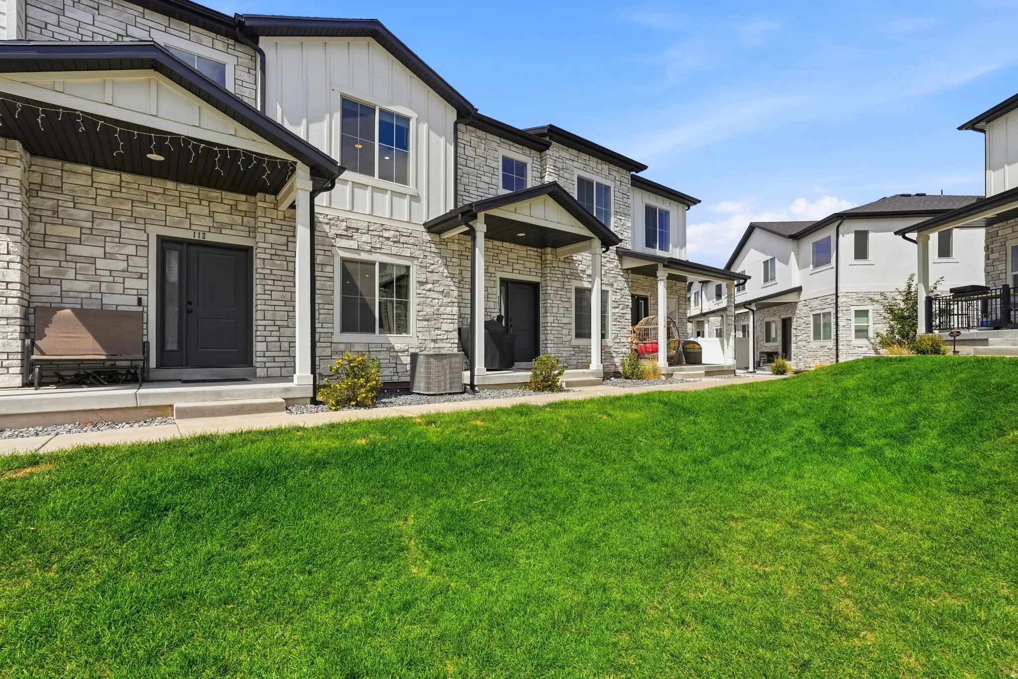 Stone veneer and vertical siding exterior