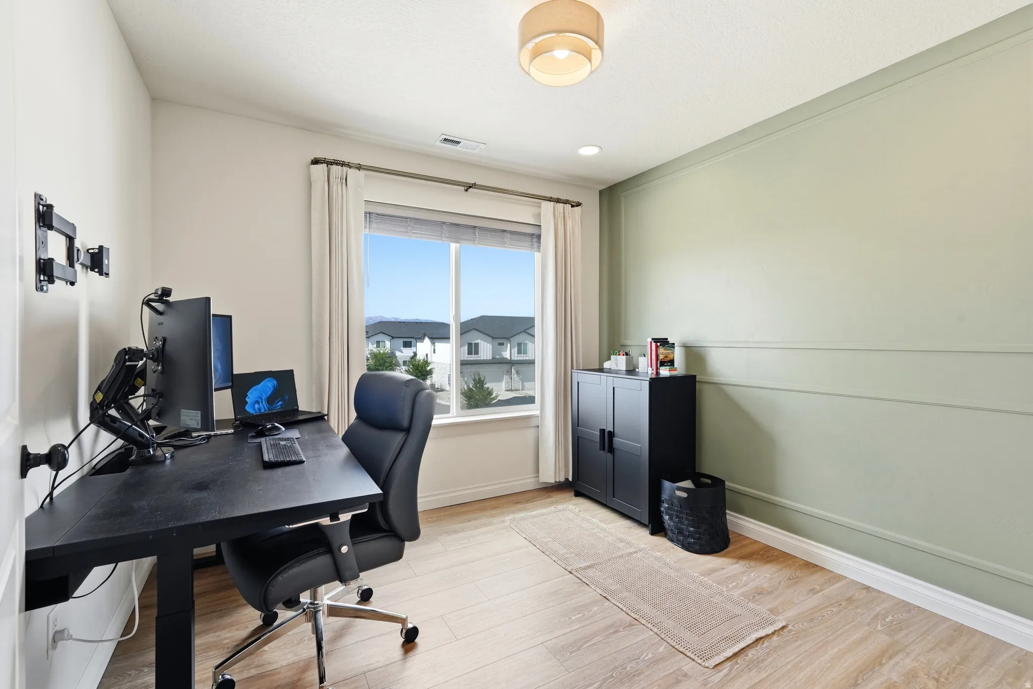 Wood-finish flooring, recessed lighting, and a window with blinds