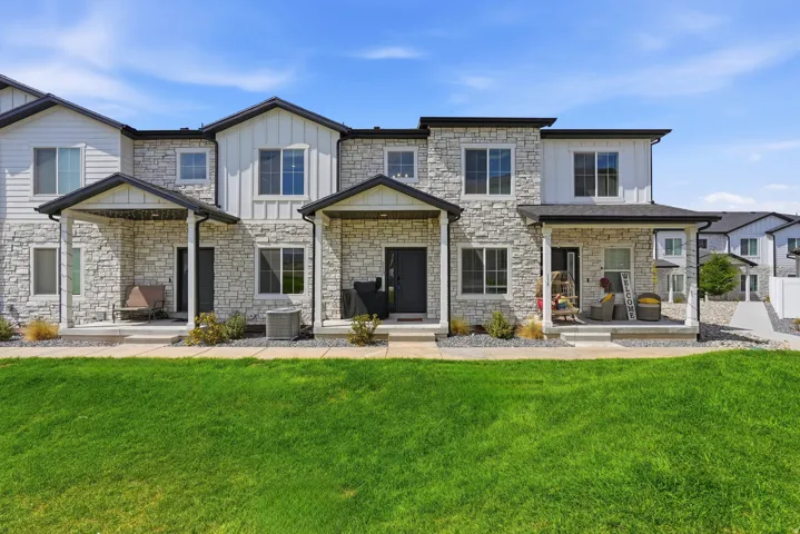 Stone veneer and siding exterior with dark trim accents