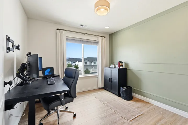 Wood-finish flooring, recessed lighting, and a window with blinds