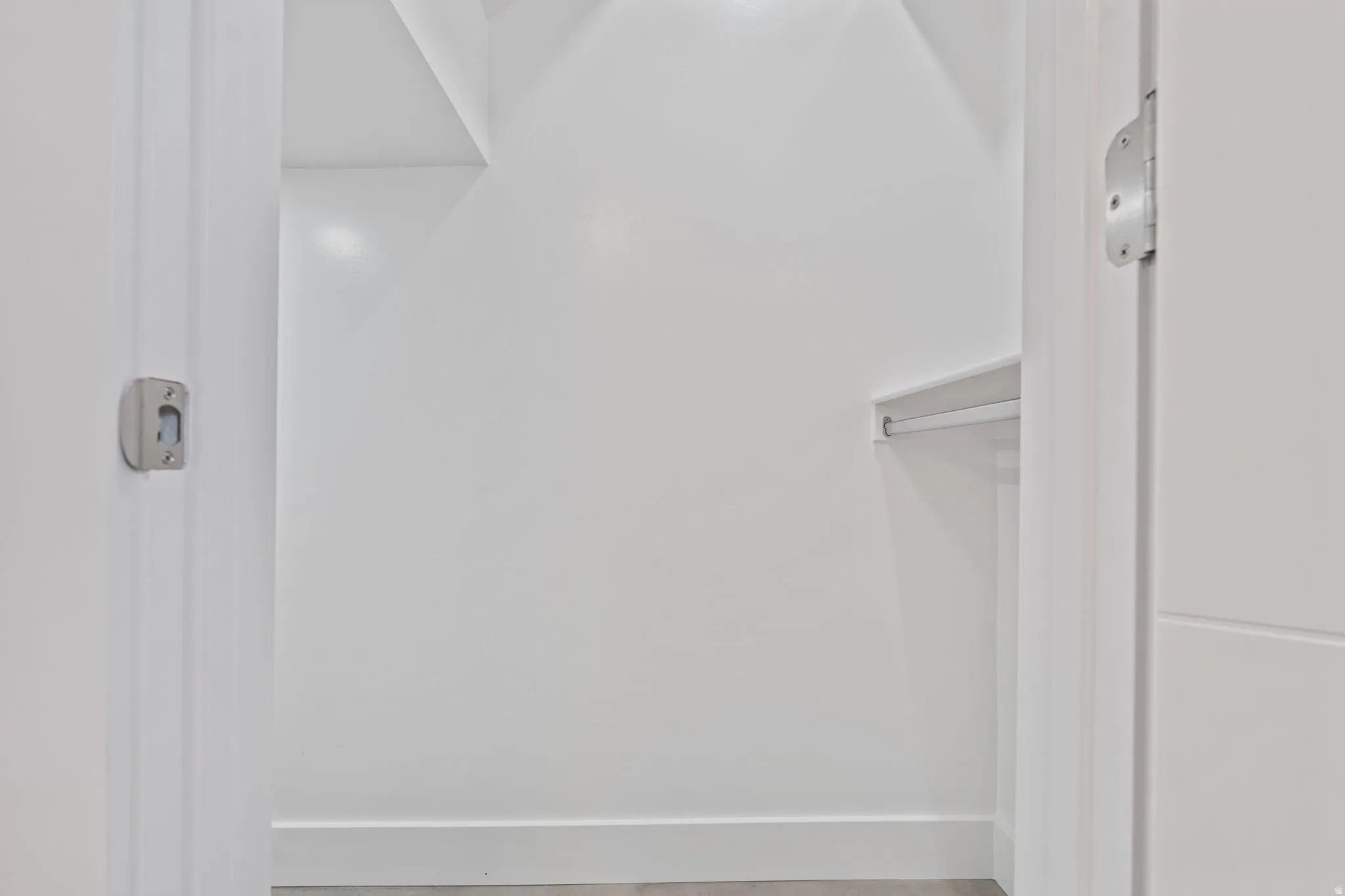 White interior with built-in shelving and hanging rod