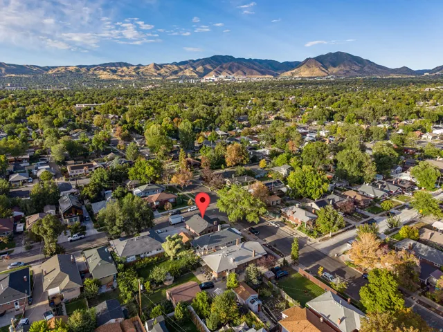 Neighborhood setting with mature trees and a distant mountain range